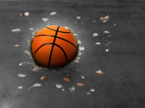 баскетбольный мяч с большой силой проникает в цементную поверхность. - the great court стоковые фото и изображения