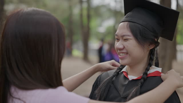 Female college student getting ready for graduation ceremony