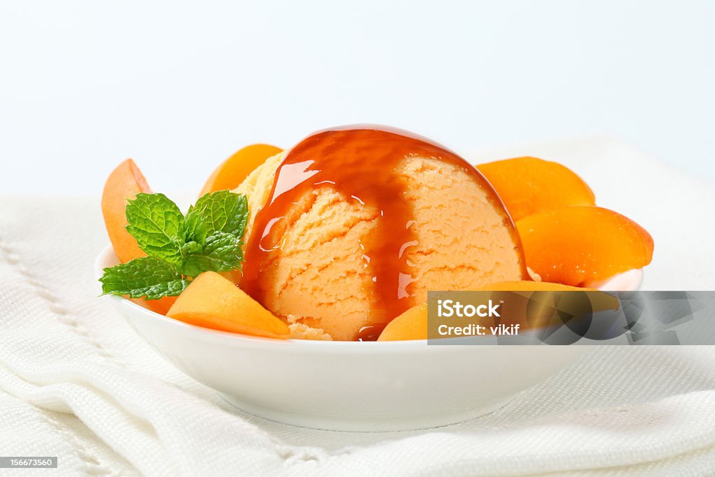 Ice cream dessert Ice cream with fresh apricot and caramel sauce Peach Ice Cream Stock Photo