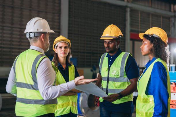 istock Team engineers and foreman stack hand and shake hands to show success at factory machines. Worker industry join hand for collaboration. 1566738435
