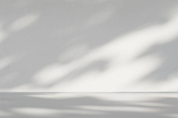 istock Gray cement background in empty room with light and shadow. 1566738990
