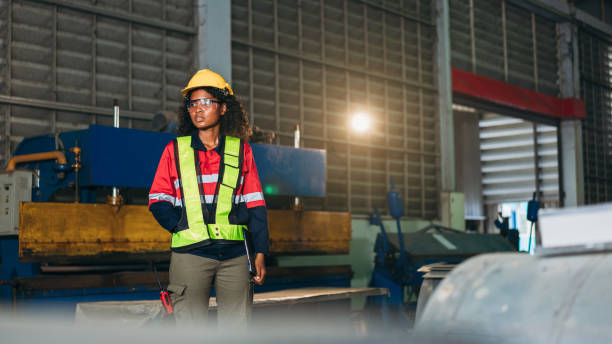 istock Industrial worker inspecting and check up machine at factory machines. Technician working in metal sheet at industry. Foreman checking Material or Machine. 1566746023