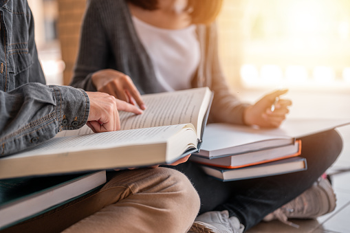 Education and Learning, Student, Campus, University, Lifestyle concept. Two students are sitting reading a books to education. Study for test preparation in University.