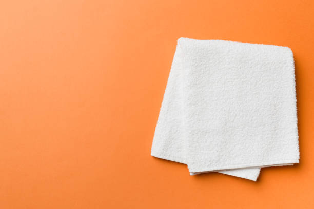 istock Top view of white towels with copy space on colored background 1566792754