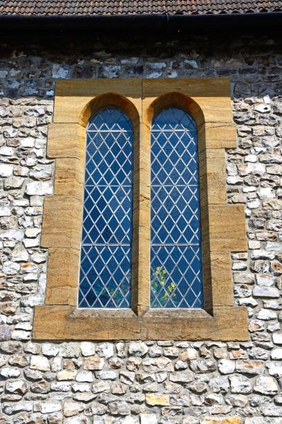 Coloured stained glass window in old church isolated on square white background with copy space and clipping path, full frame square composition