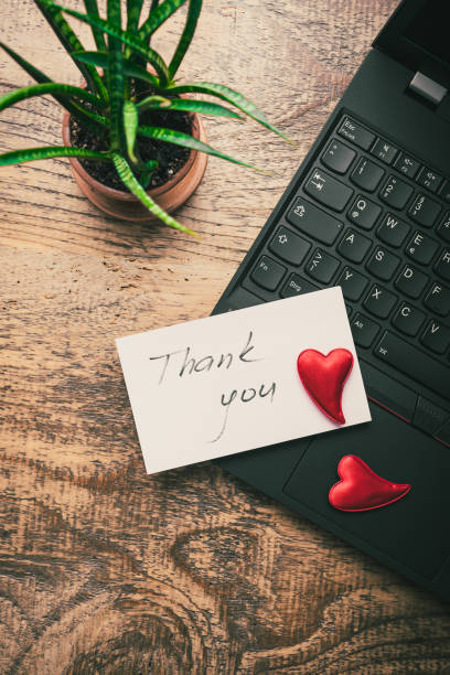 istock Thank you concept on the sticky note paper -  notebook and plant 1566810822