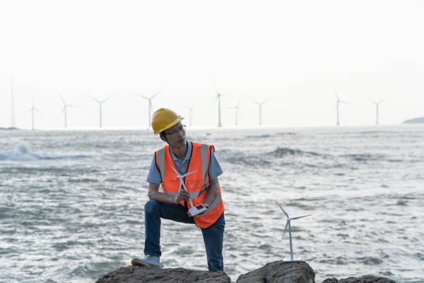 istock A wind farm technician by the sea is thinking 1566813614
