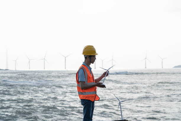 istock Wind farm technician researching by the sea 1566813615