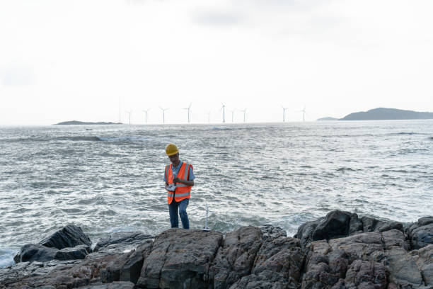 istock Wind farm technician by the sea 1566813625