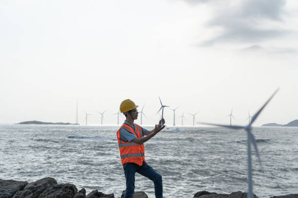 istock Male technicians at an offshore wind farm at work 1566813894