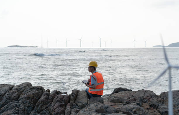 istock Male technicians at an offshore wind farm at work 1566814203