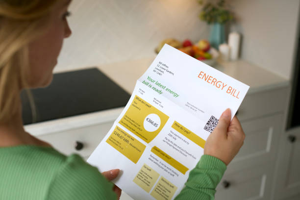 close up of woman opening euro energy bill during cost of living crisis - räkning bildbanksfoton och bilder