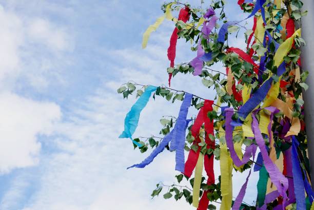 istock May tree decorated with colorful ribbons against sky. Young couples traditional gift on May first in Germany, with copy space 1566824016