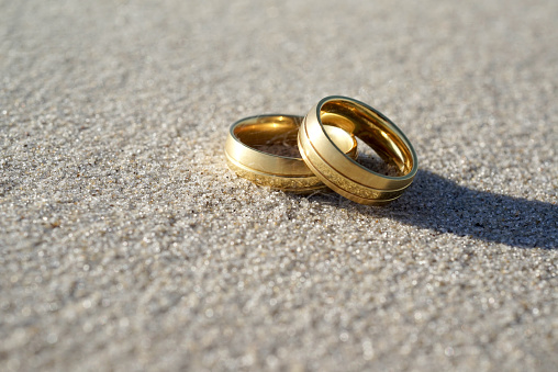 Wedding rings on the sand
