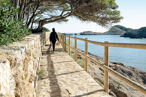 woman enjoying a sunny day trekking on the Costa brava
 mediterranean coast