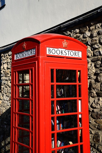 Red telephone box turned into a bookstore along the High Street, Chard, Somerset, UK, Europe.