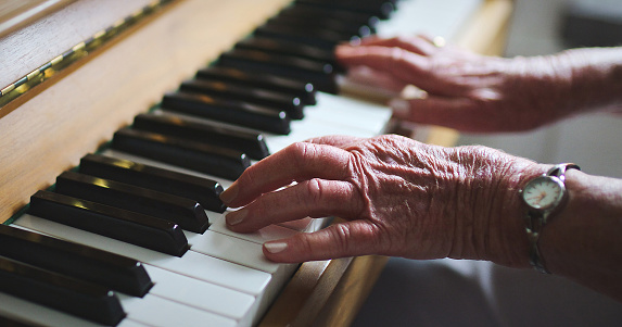 Piano, woman and hands on keys for music, creative talent and skills in a lounge, home and audio performance. Closeup, musician or pianist playing synthesizer keyboard with sound artist or instrument