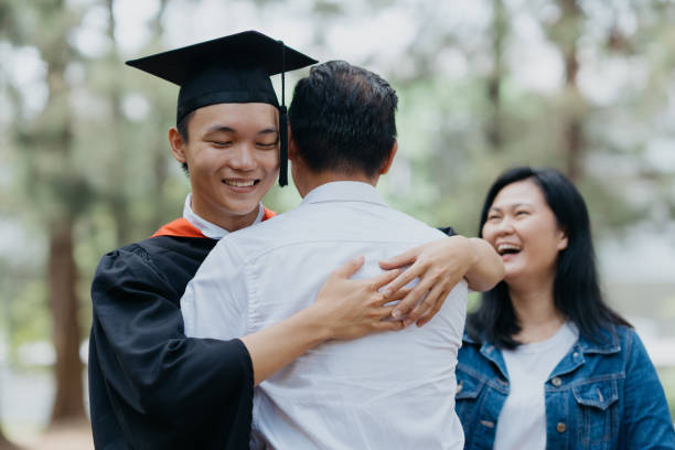 istock Young asian graduate student hugging his father 1566847855