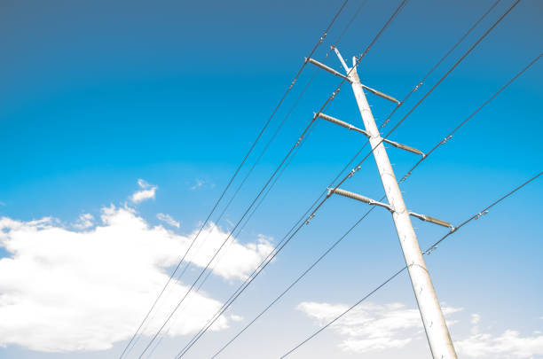 High Voltage Overhead power line is a structure used in electric power transmission and distribution standing against blue sky day.