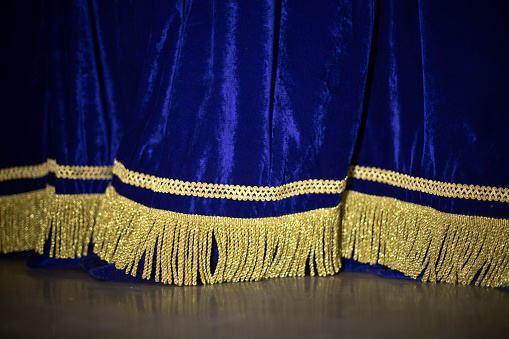Blue Curtain. Curtain on stage. Blue fabric. Details of theater.