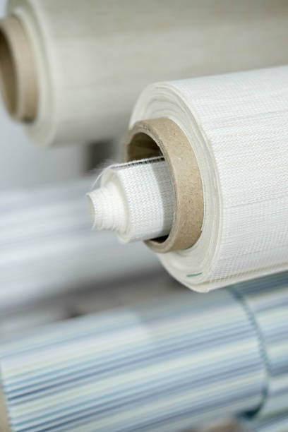 istock Rolls of fabric for roller blinds are in production 1566879964