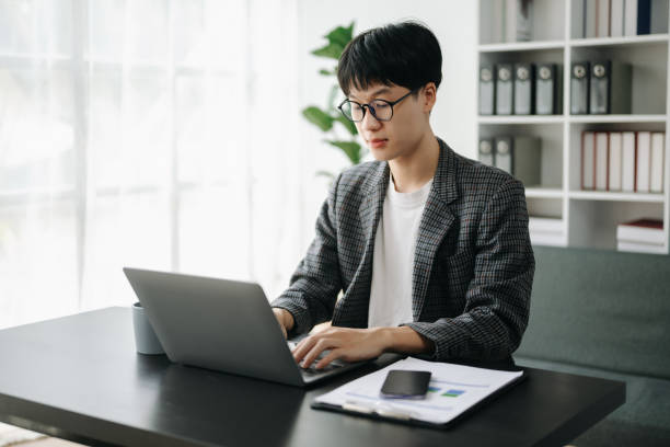 istock Young business man executive manager looking at laptop watching online webinar training or having virtual meeting video conference doing market research working in office. 1566893061