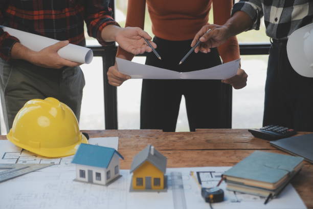 istock Engineer Teamwork Meeting, Drawing working on blueprint meeting for project working with partner on model building and engineering tools in working site, Construction and structure concept. 1566896889