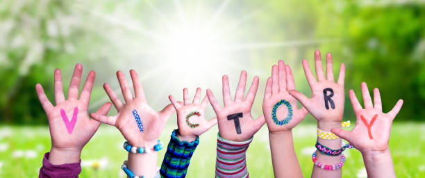 istock Children Hands Building Word Victory, Grass Meadow 1566927156