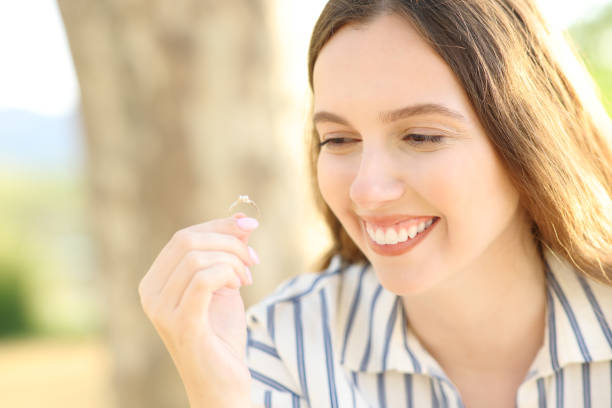 istock Happy fiancee enjoying looking at engagement ring 1566935425