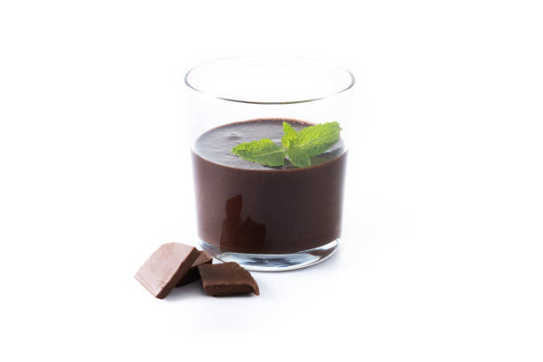 istock Chocolate mousse dessert garnished with mint leaf isolated on white background 1566936341