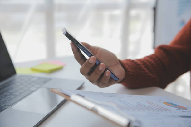 istock Asian Businesswoman Using laptop computer and working at office with calculator document on desk, doing planning analyzing the financial report, business plan investment, finance analysis concept. 1566939315