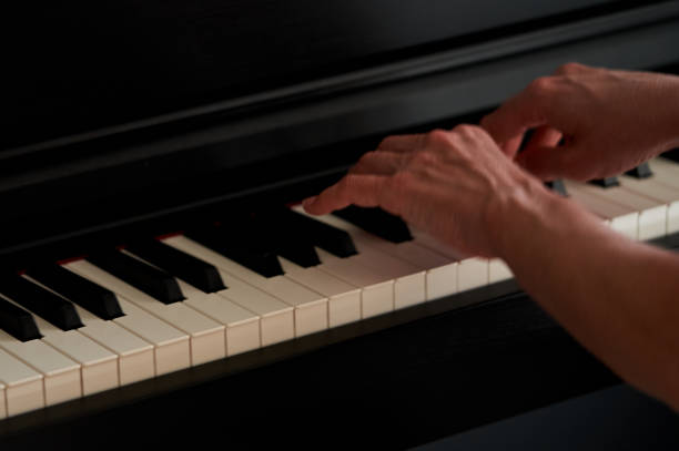 istock keyboard and hands playing the piano 1566943063