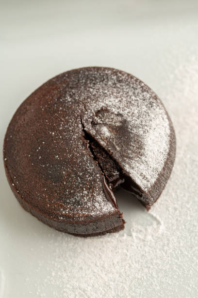 istock Chocolate souffle with flowing chocolate on a white porcelain plate 1566946712