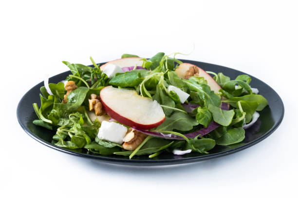 istock Autumn salad with apples and walnuts isolated on white background 1566951832