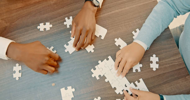istock Employees, strategy and hands with brainstorming in top view with problem solving at desk in company. Ideas, help and collaboration with teamwork or puzzle for support together in workplace for job. 1566955799