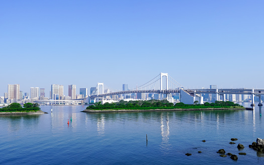 Rainbow Bridge from the observation deck of Odaiba Kaihin Park on a sunny day in May 2023 in the bay area of Minato Ward, Tokyo
