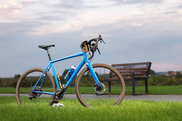 istock Professional gravel bicycle with different accessories standing on a green lawn 1566982709