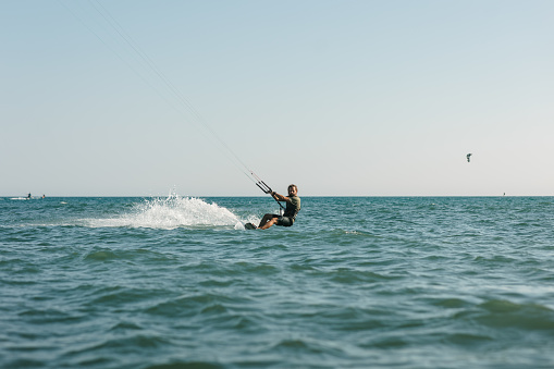 Kite surfer riding on a kiteboard in Montenegro, Ada Bojana