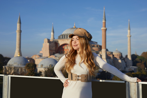 a fashionable Russian lady looking like asian posing on a terrace near Hagia Sofia