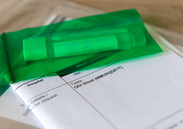 istock A sample container and a medical form for a Qfit Stool test. 1566989850
