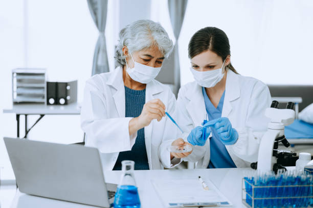 istock Modern medical research laboratory. female scientist working with micro pipettes analyzing biochemical samples, advanced science chemical laboratory for medicine. 1566990427