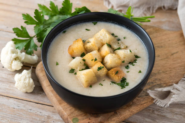 istock Cauliflower soup in a bowl on wooden table 1566993119
