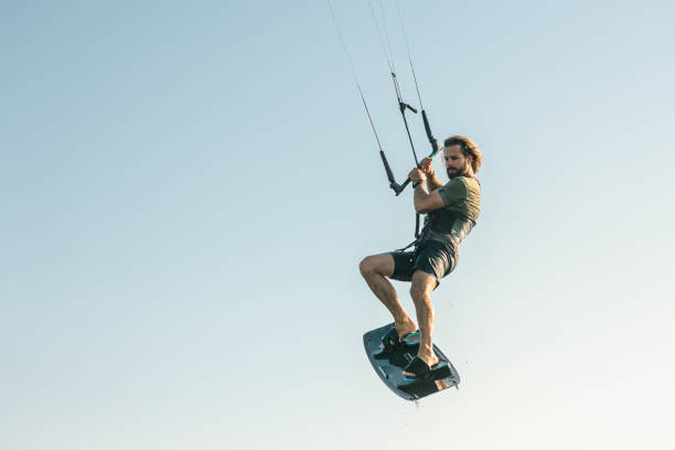 istock Kite surfer on a kite board in the air 1566994185