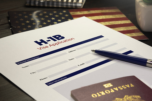 H-1b visa application concept: USA H-1B visa application on a table with a passport