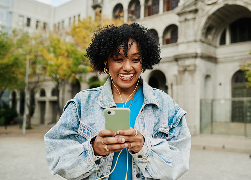 a modern mature woman listening to her music in the city, copy space, stock photo