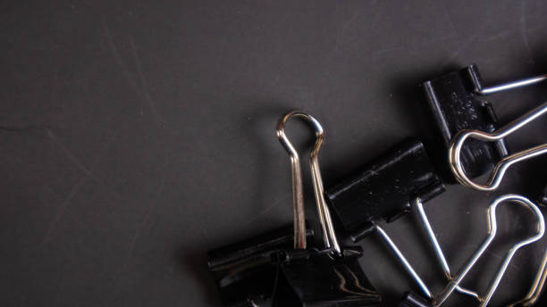 istock a black paper clip on a black background 1567016384