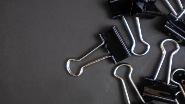 istock a black paper clip on a black background 1567017011