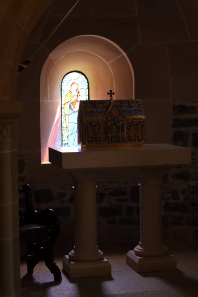 istock Light shining through a stained glass window in a chapel 1567040127