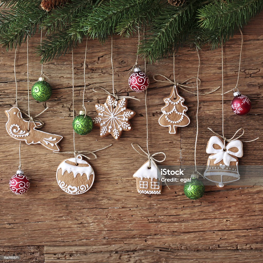 Gingerbread cookies Gingerbread cookies hanging over wooden background Baked Stock Photo