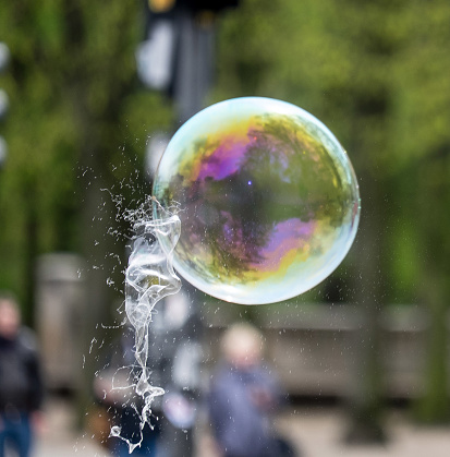 one bubble bursting against another, reflections, green background, art, speed,